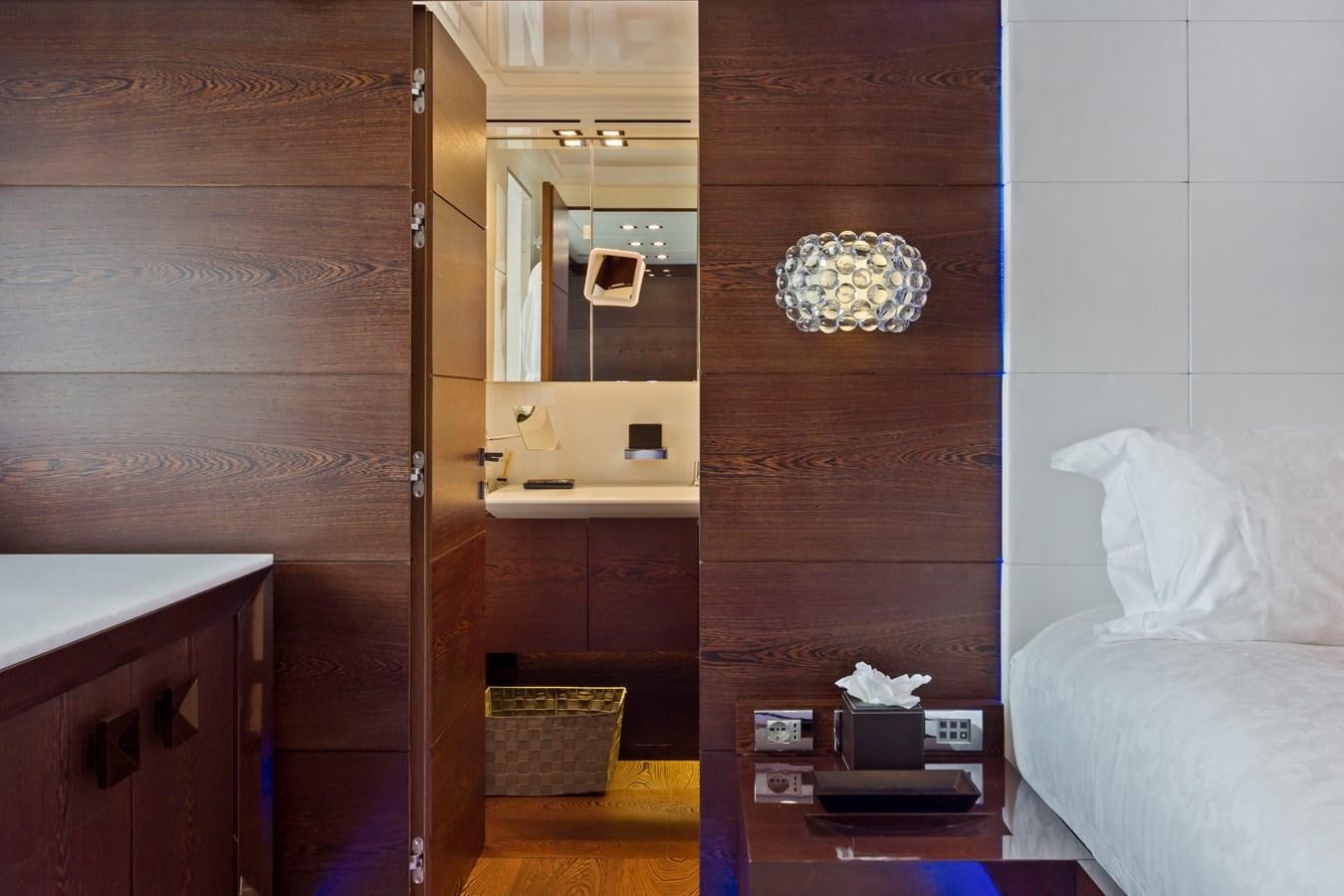 a room with a bed and a mirror aboard FIVE WAVES Yacht for Sale