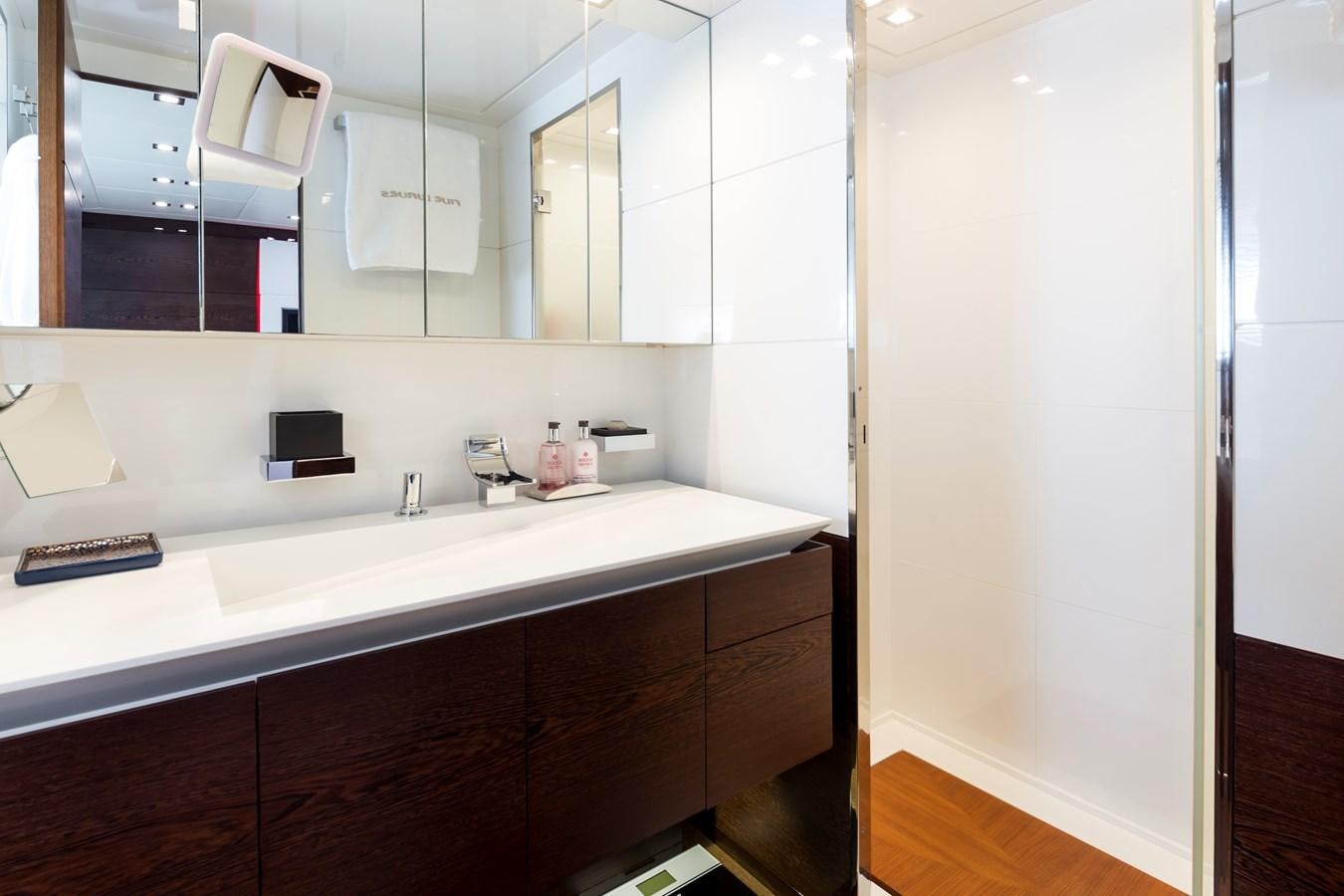 a bathroom with a sink and a mirror aboard FIVE WAVES Yacht for Sale