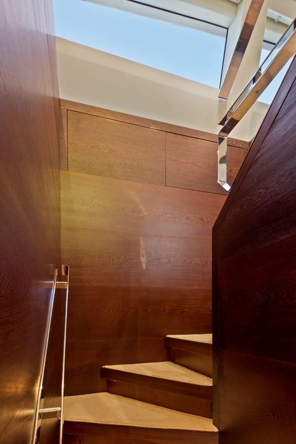 a wooden staircase with a railing aboard FIVE WAVES Yacht for Sale