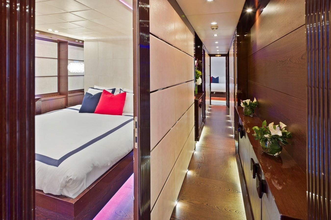 a bedroom with a bed and a table aboard FIVE WAVES Yacht for Sale