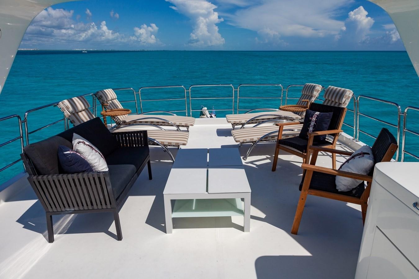 a group of chairs on a deck overlooking the ocean aboard SUNRISE Yacht for Sale