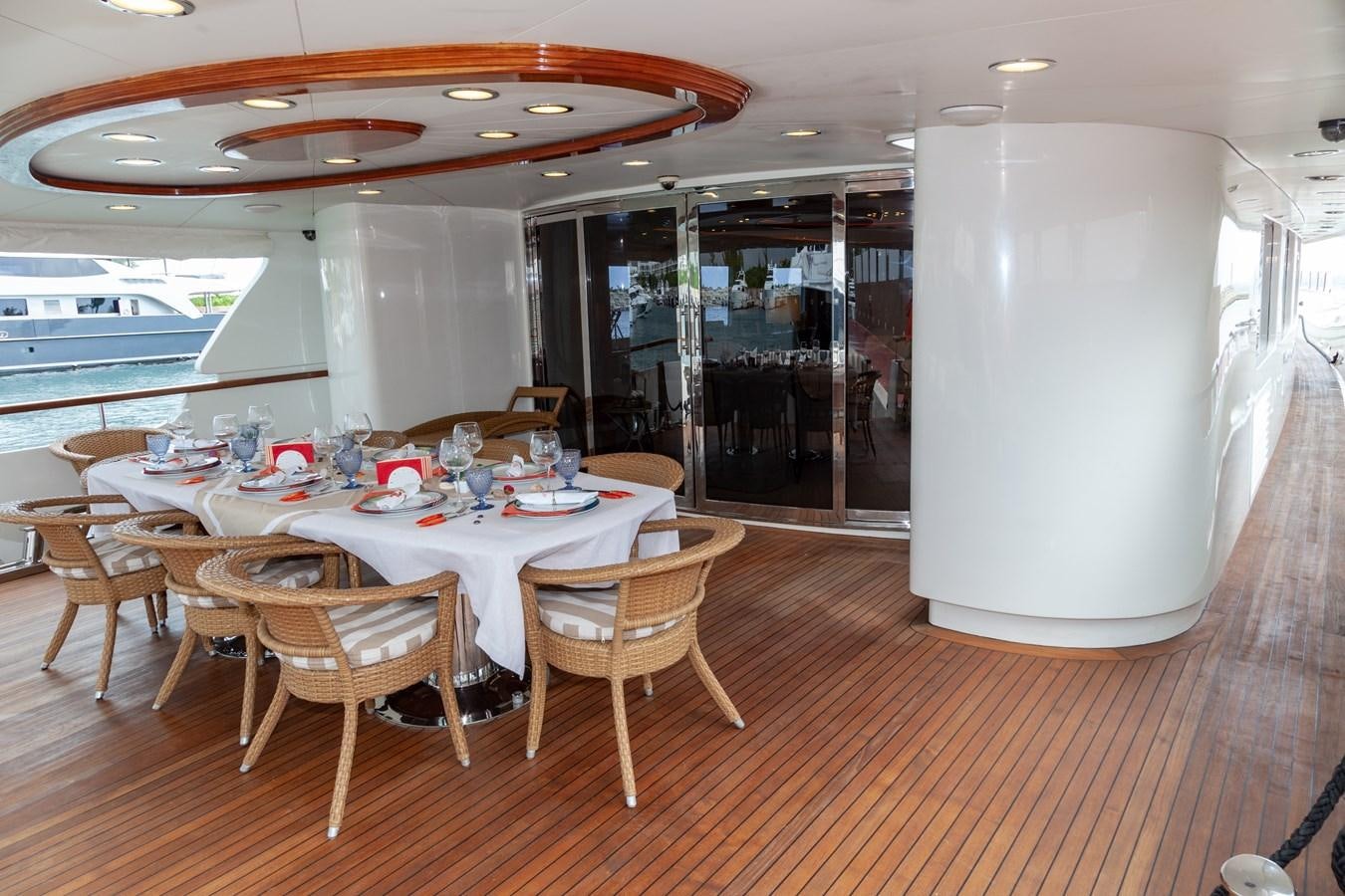 a room with tables and chairs aboard SUNRISE Yacht for Sale