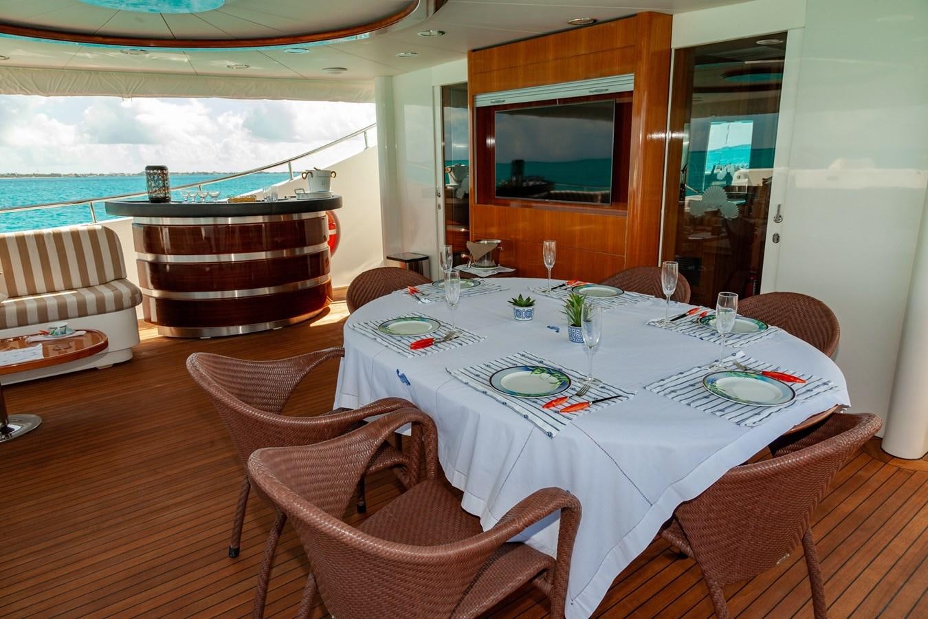 a dining table set for a meal aboard SUNRISE Yacht for Sale