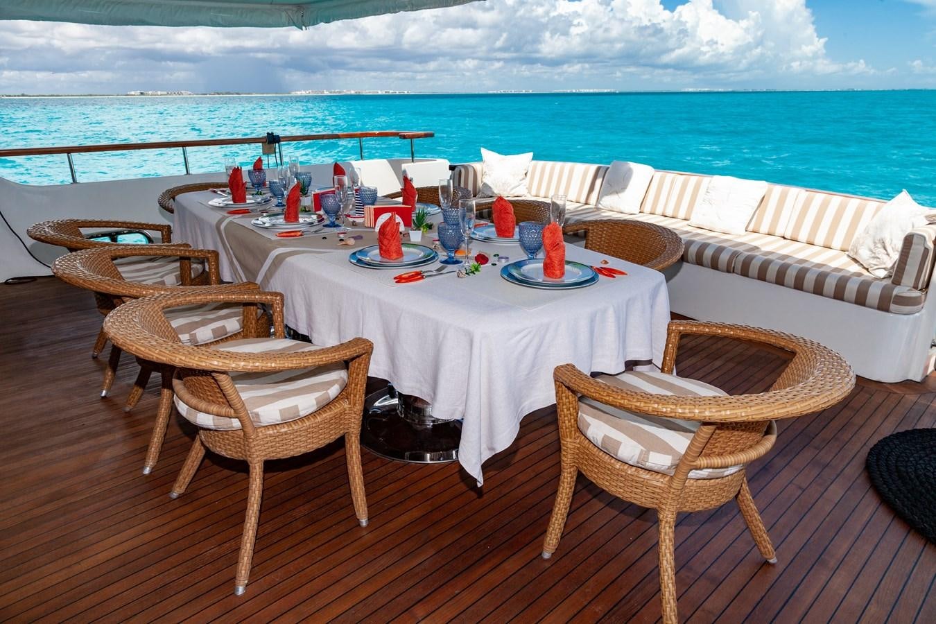 a table set on a deck overlooking the ocean aboard SUNRISE Yacht for Sale