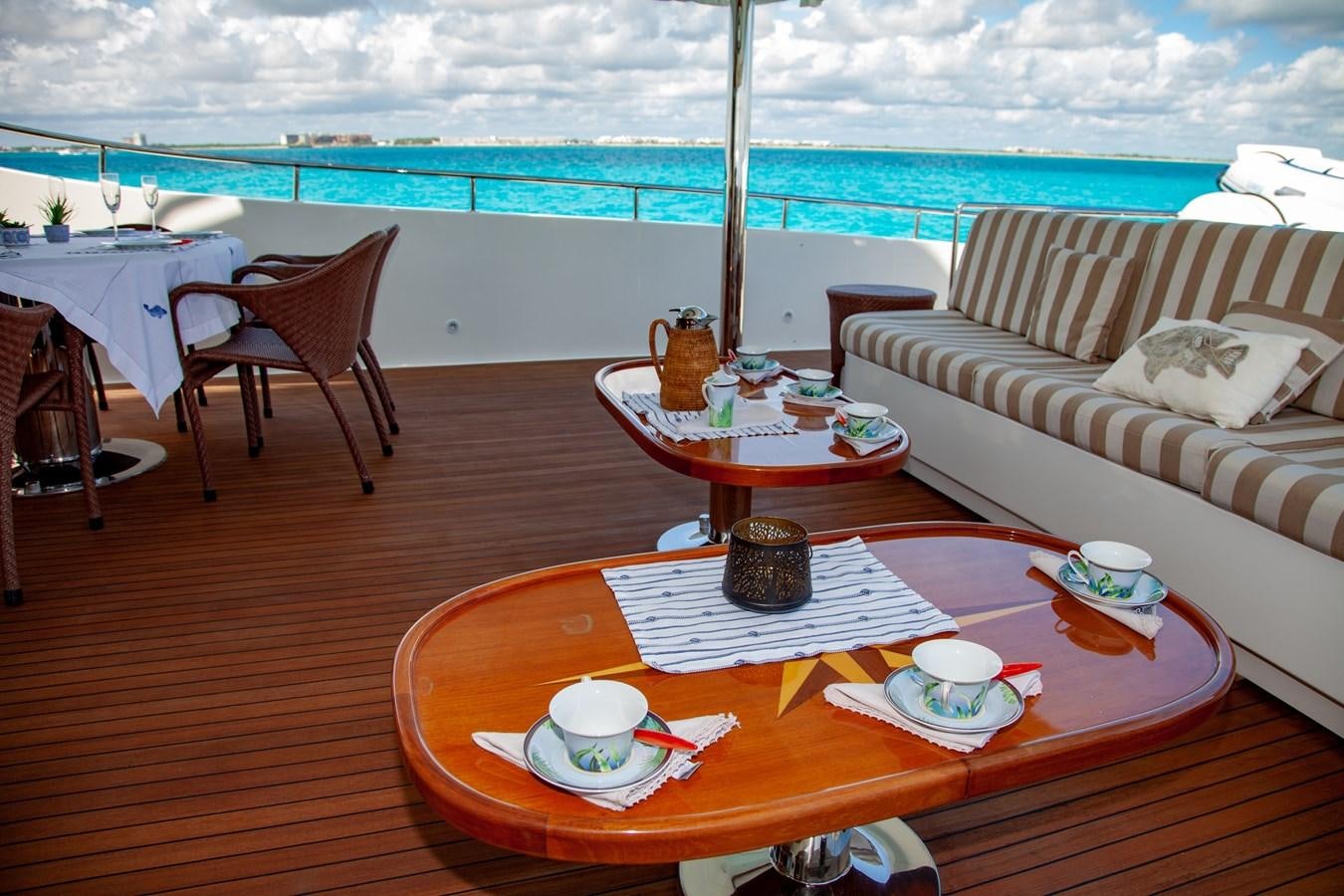 a table with cups and plates on it aboard SUNRISE Yacht for Sale