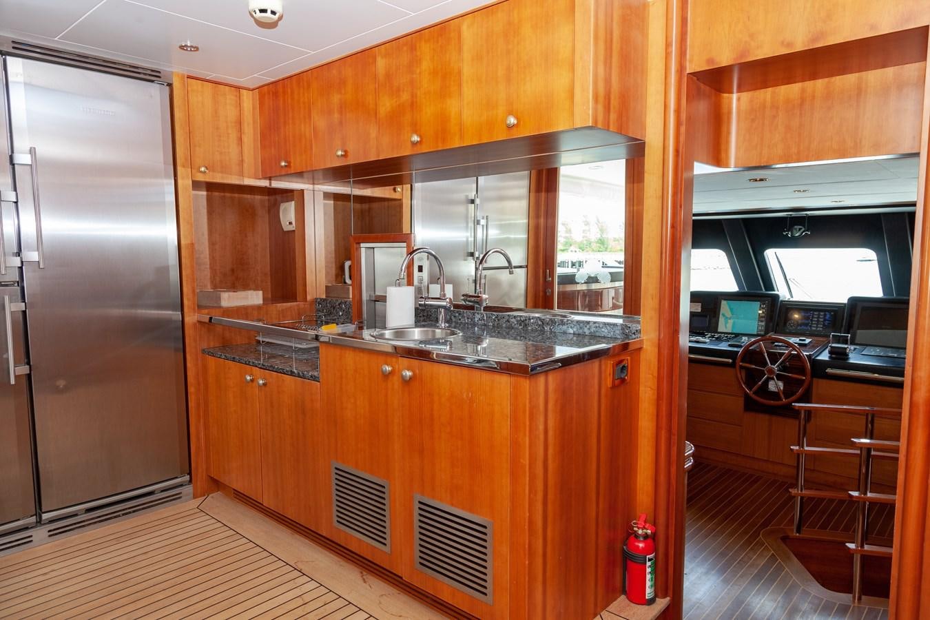 a kitchen with wooden cabinets aboard SUNRISE Yacht for Sale