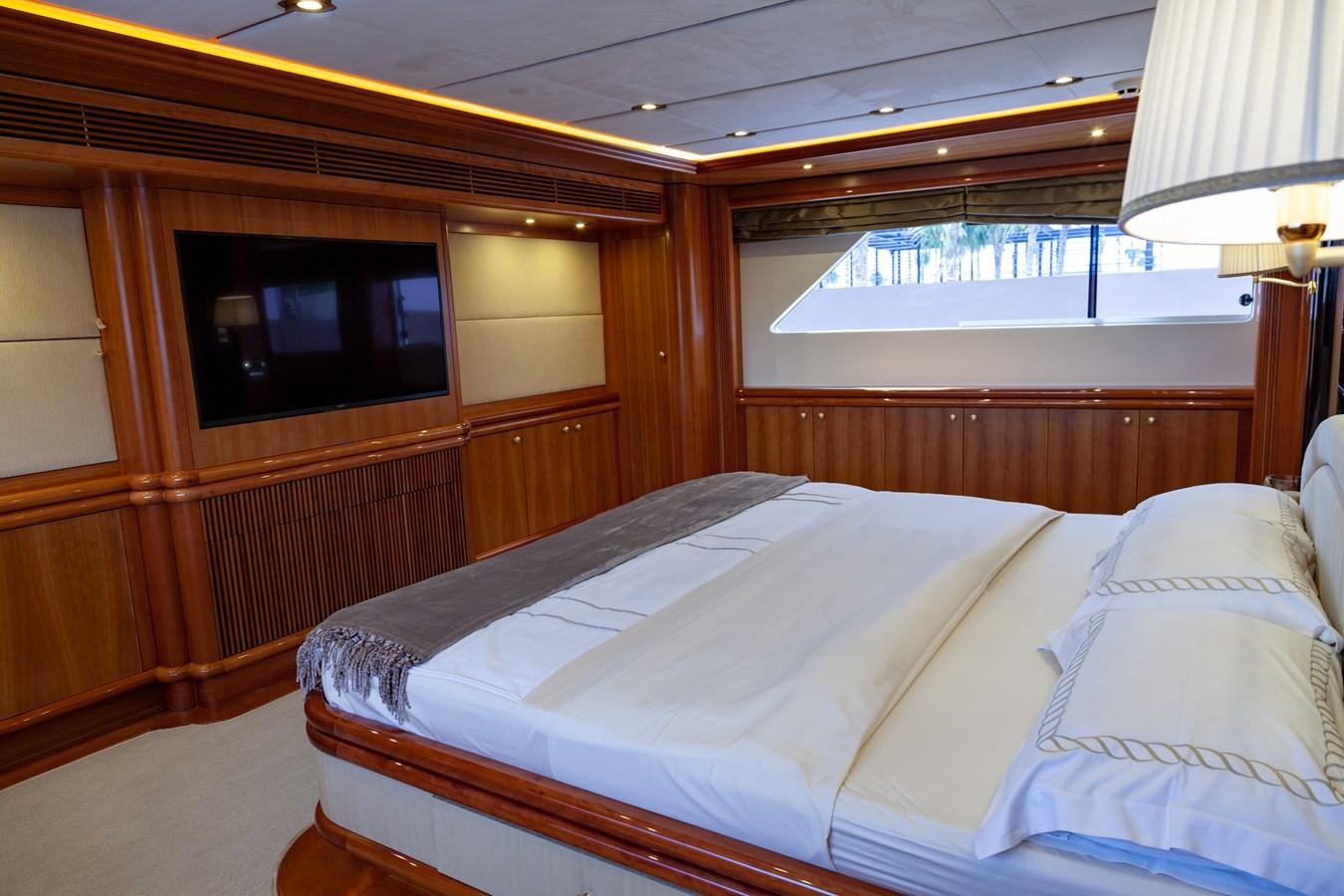 a bed with a television on the wall aboard SUNRISE Yacht for Sale