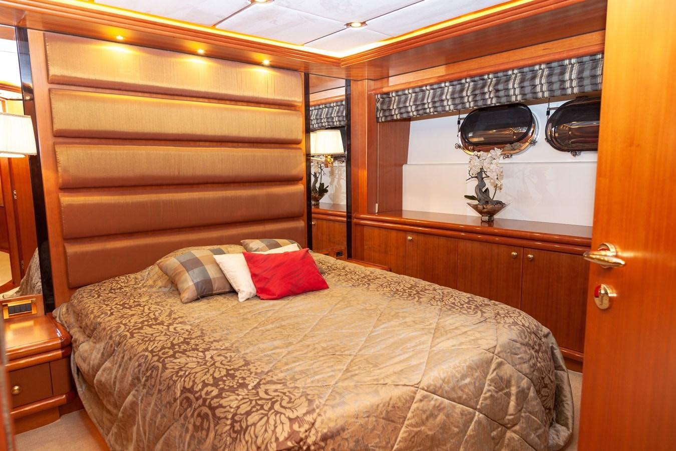a bed with a wooden headboard aboard SUNRISE Yacht for Sale