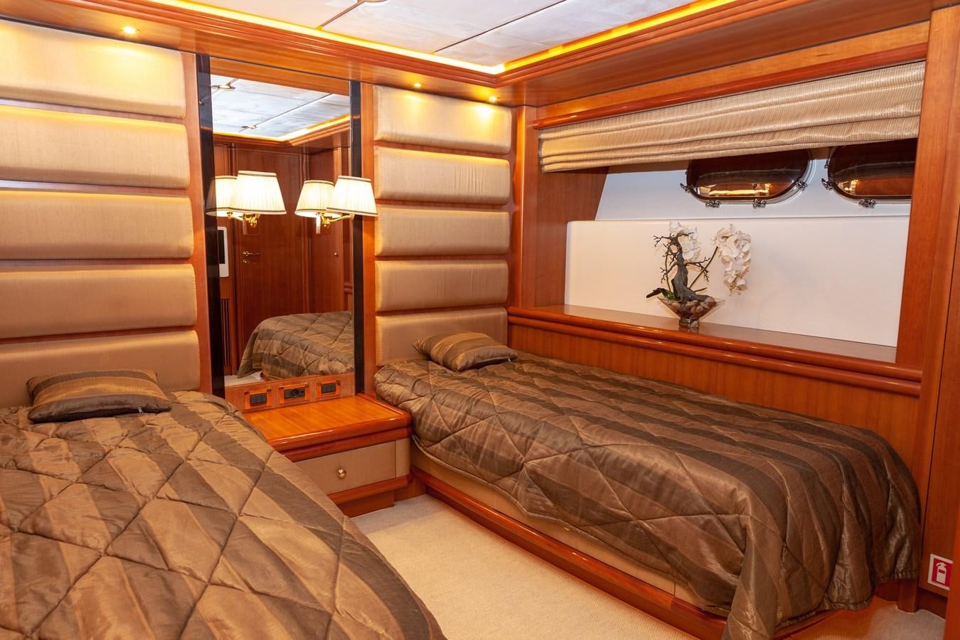 a room with a bed and a mirror aboard SUNRISE Yacht for Sale