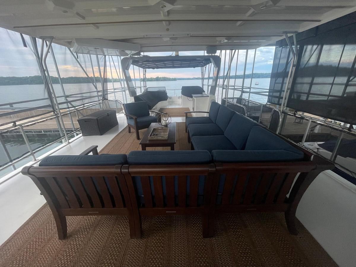 a room with chairs and tables aboard 2005 HORIZON 18X88 HOUSEBOAT Yacht for Sale