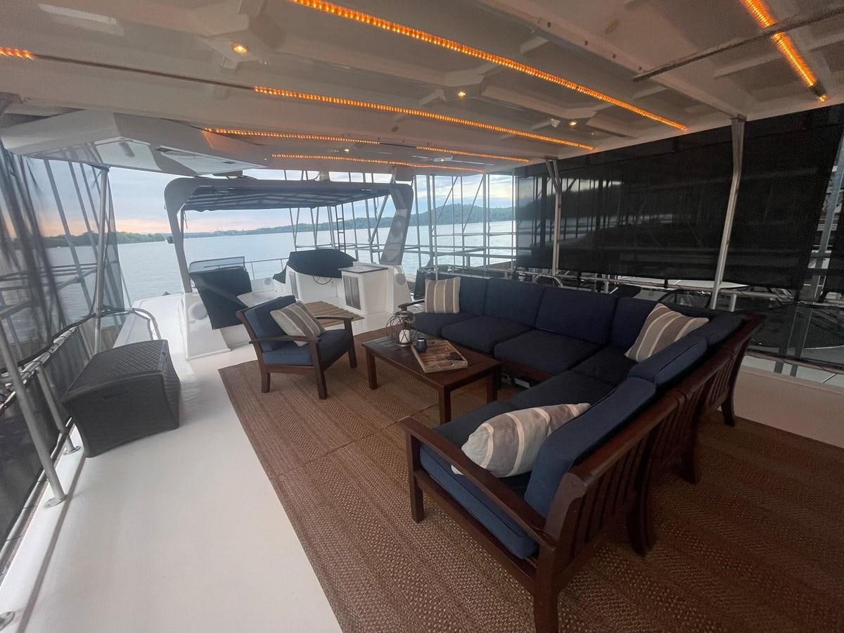 a room with a couch and a table aboard 2005 HORIZON 18X88 HOUSEBOAT Yacht for Sale