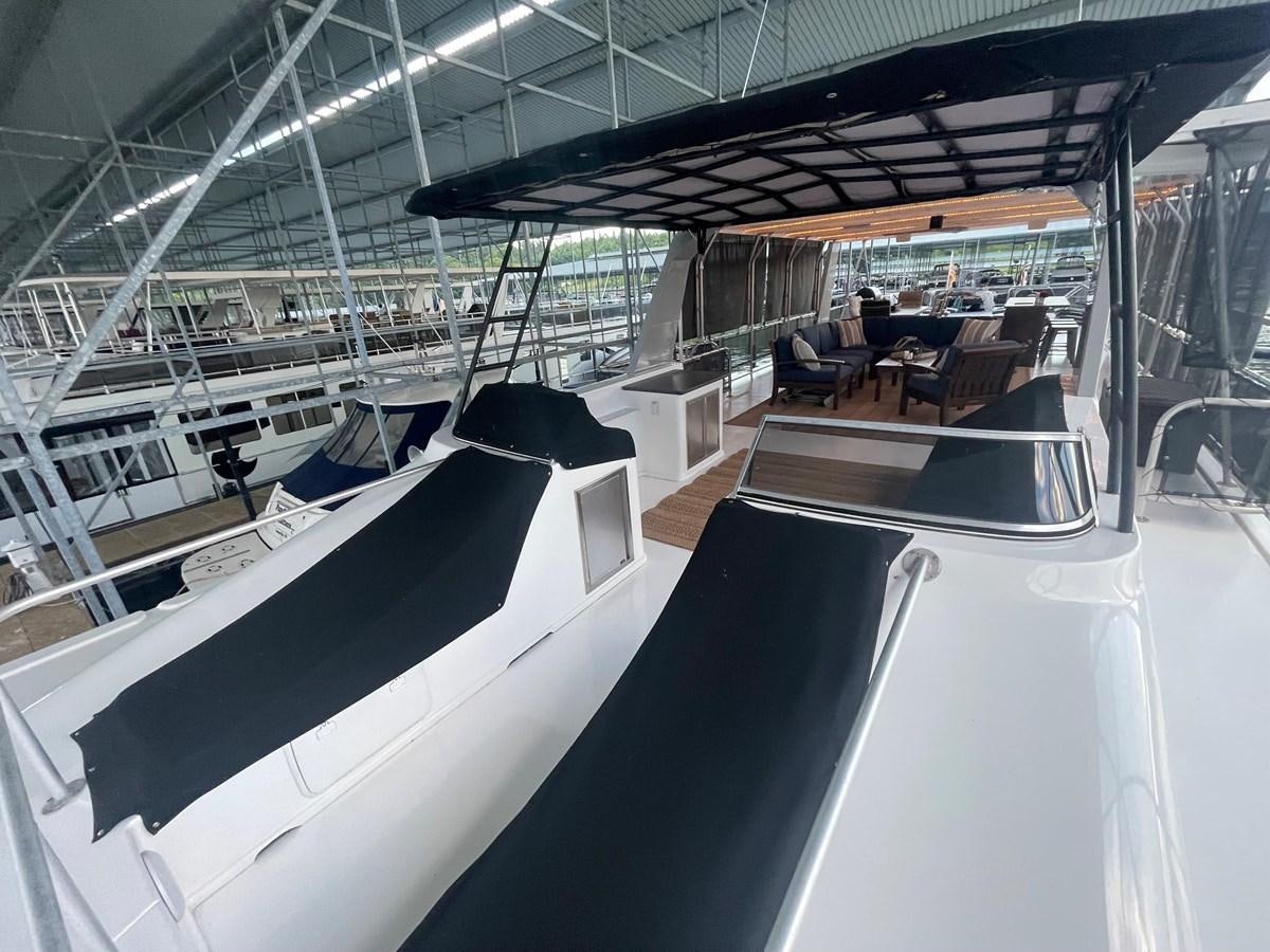 a large room with a large white boat in it aboard 2005 HORIZON 18X88 HOUSEBOAT Yacht for Sale