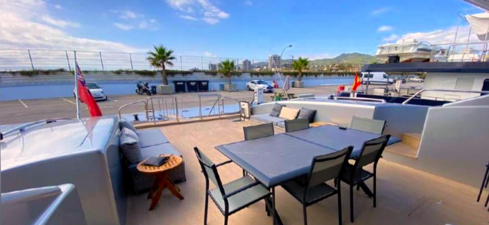 a table and chairs on a deck aboard ESCAPE MANA Yacht for Sale