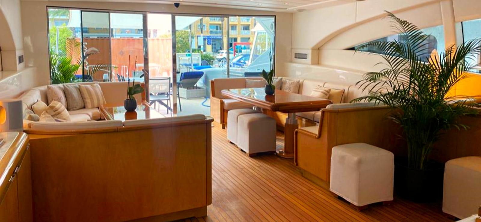 a living room with a table and chairs aboard ESCAPE MANA Yacht for Sale