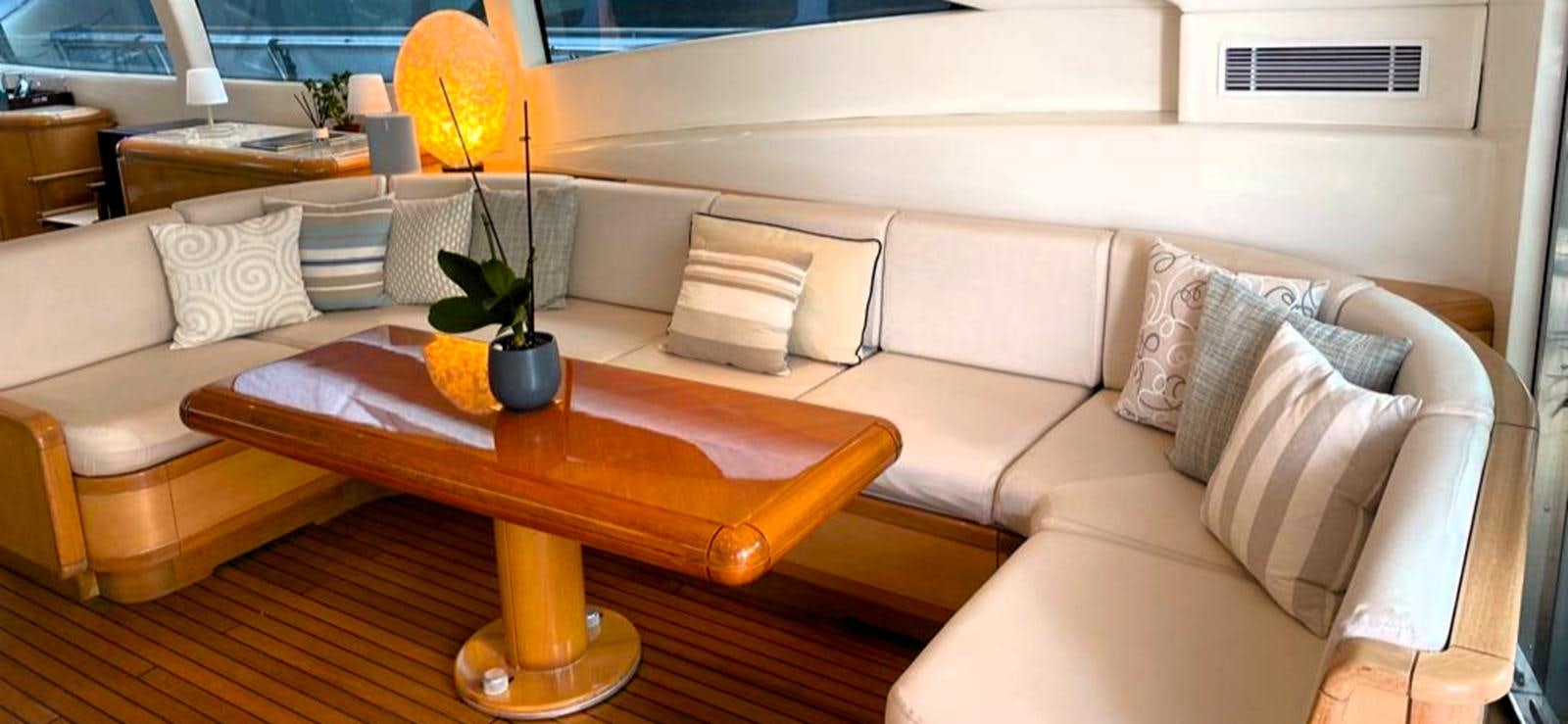a living room with a white couch and a coffee table aboard ESCAPE MANA Yacht for Sale