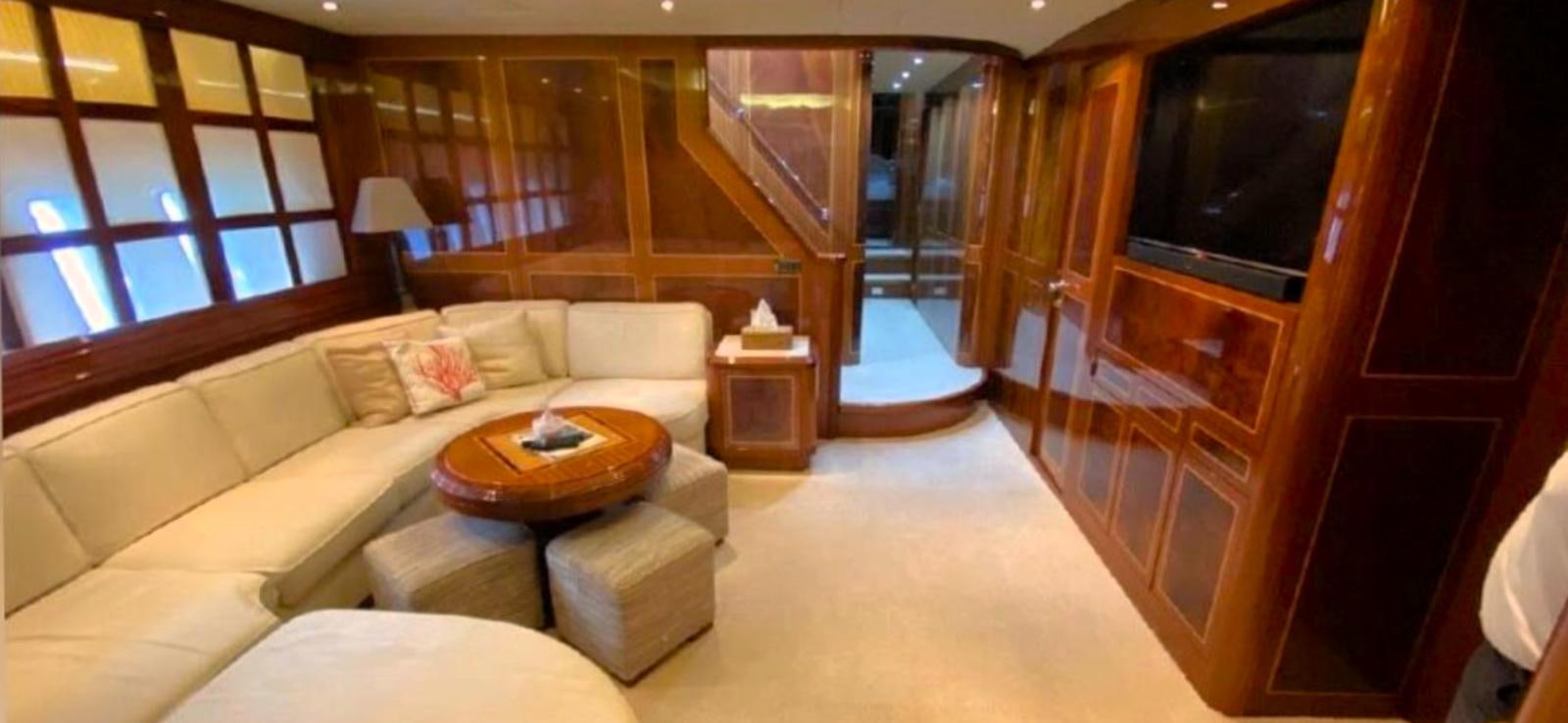 a living room with a large wood staircase aboard ESCAPE MANA Yacht for Sale