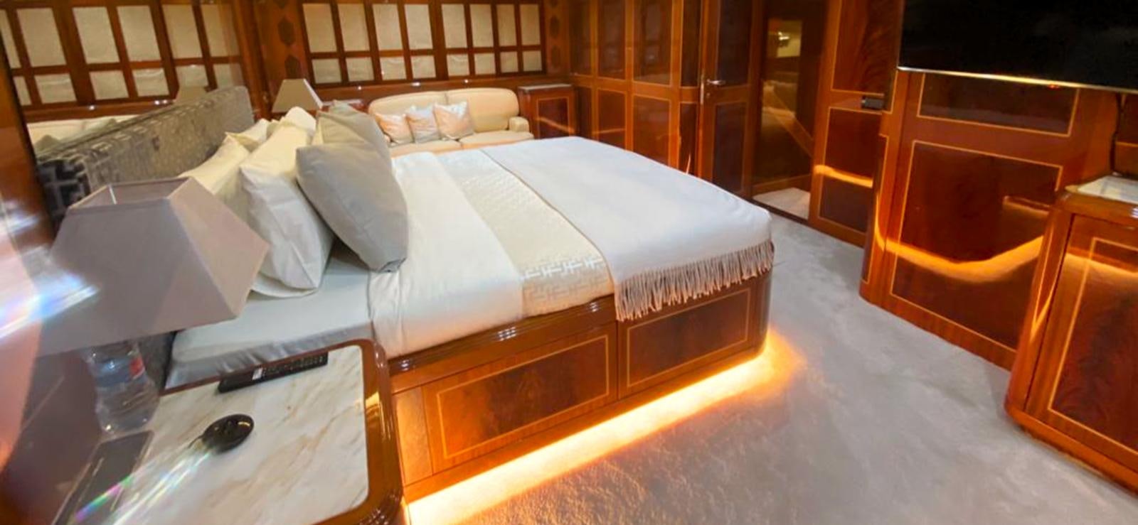 a bed with a white sheet aboard ESCAPE MANA Yacht for Sale