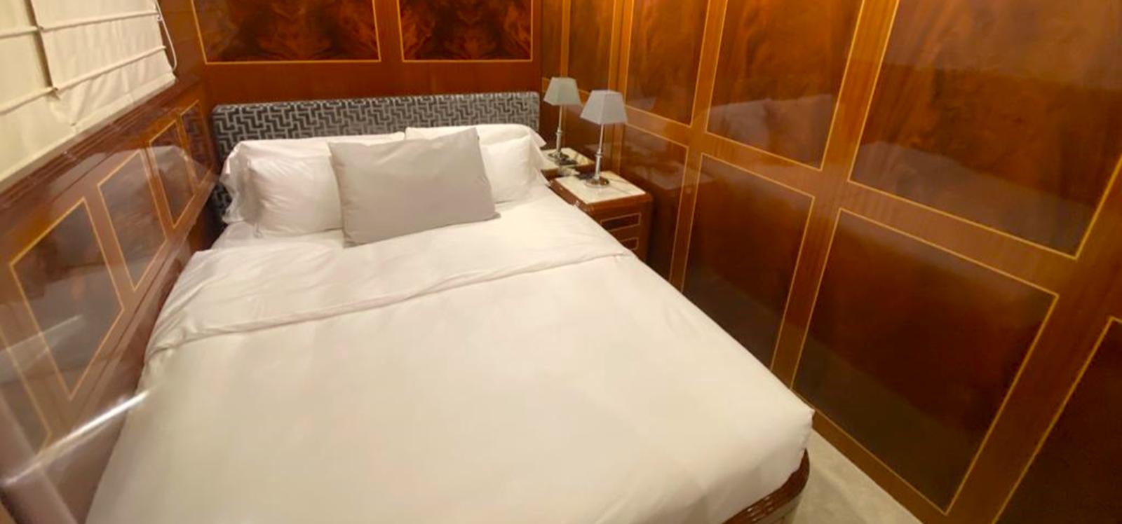 a bed with white sheets aboard ESCAPE MANA Yacht for Sale