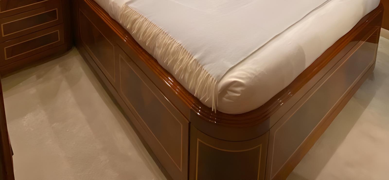 a bed with white sheets aboard ESCAPE MANA Yacht for Sale