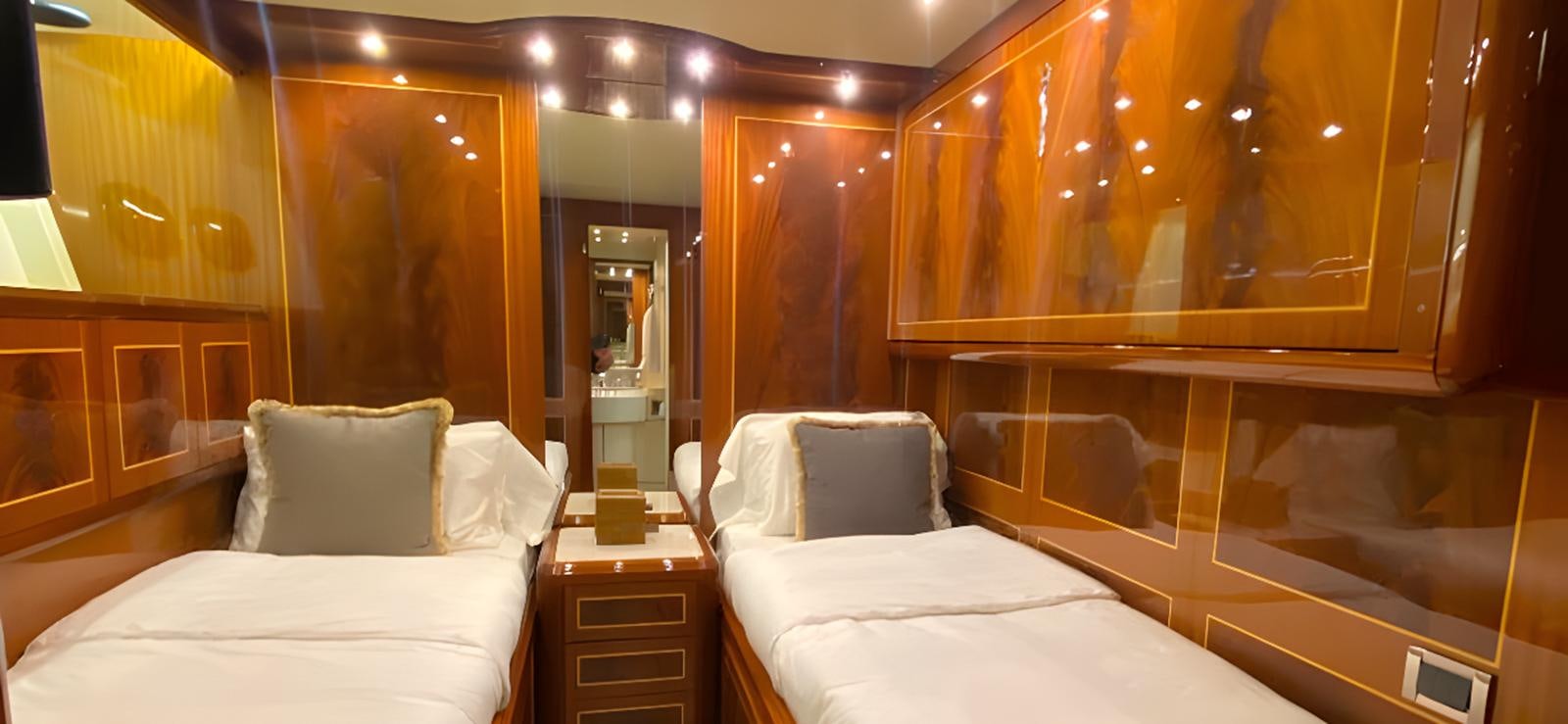 a room with beds and a mirror aboard ESCAPE MANA Yacht for Sale