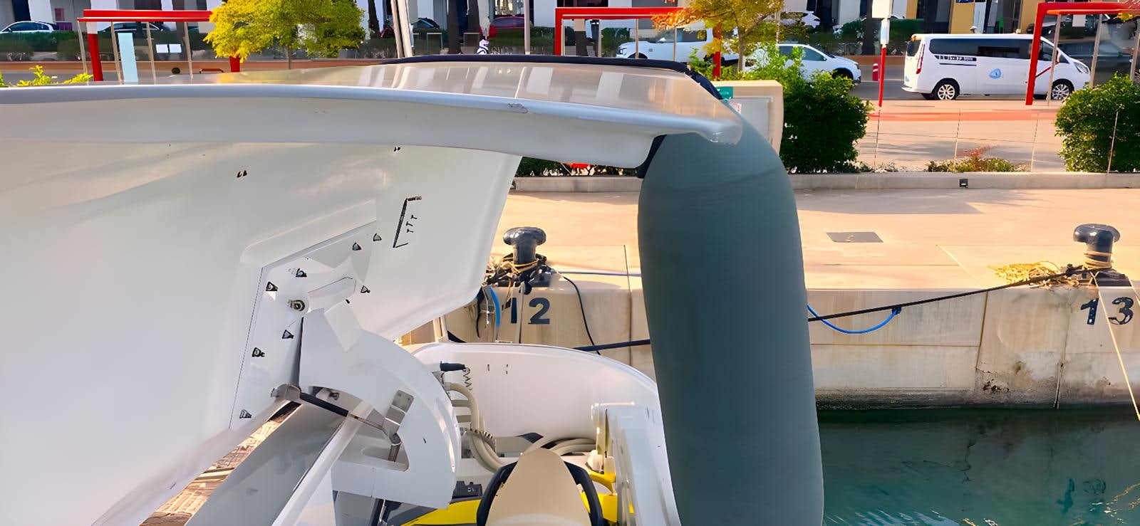 a white boat on a dock aboard ESCAPE MANA Yacht for Sale