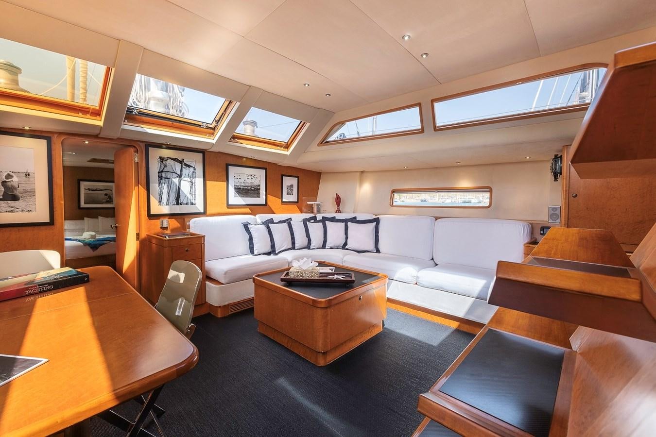 a living room with a couch and a table aboard FANTASEA Yacht for Sale