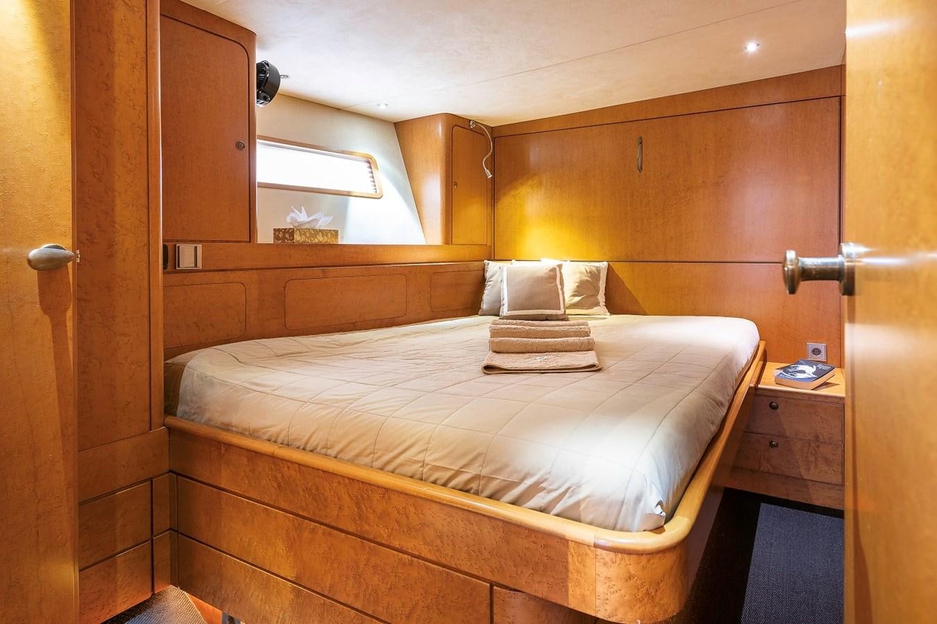 a bed with white sheets aboard FANTASEA Yacht for Sale