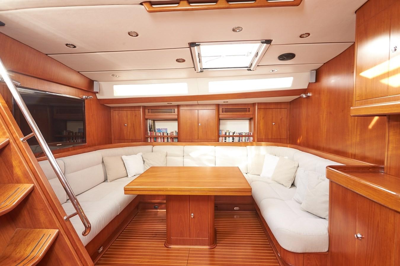 a room with a couch and a table aboard FAR OUT Yacht for Sale