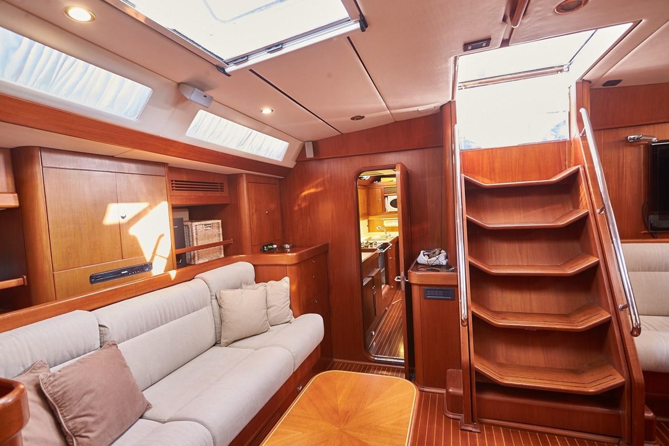 a cabin with a bed and a couch aboard FAR OUT Yacht for Sale