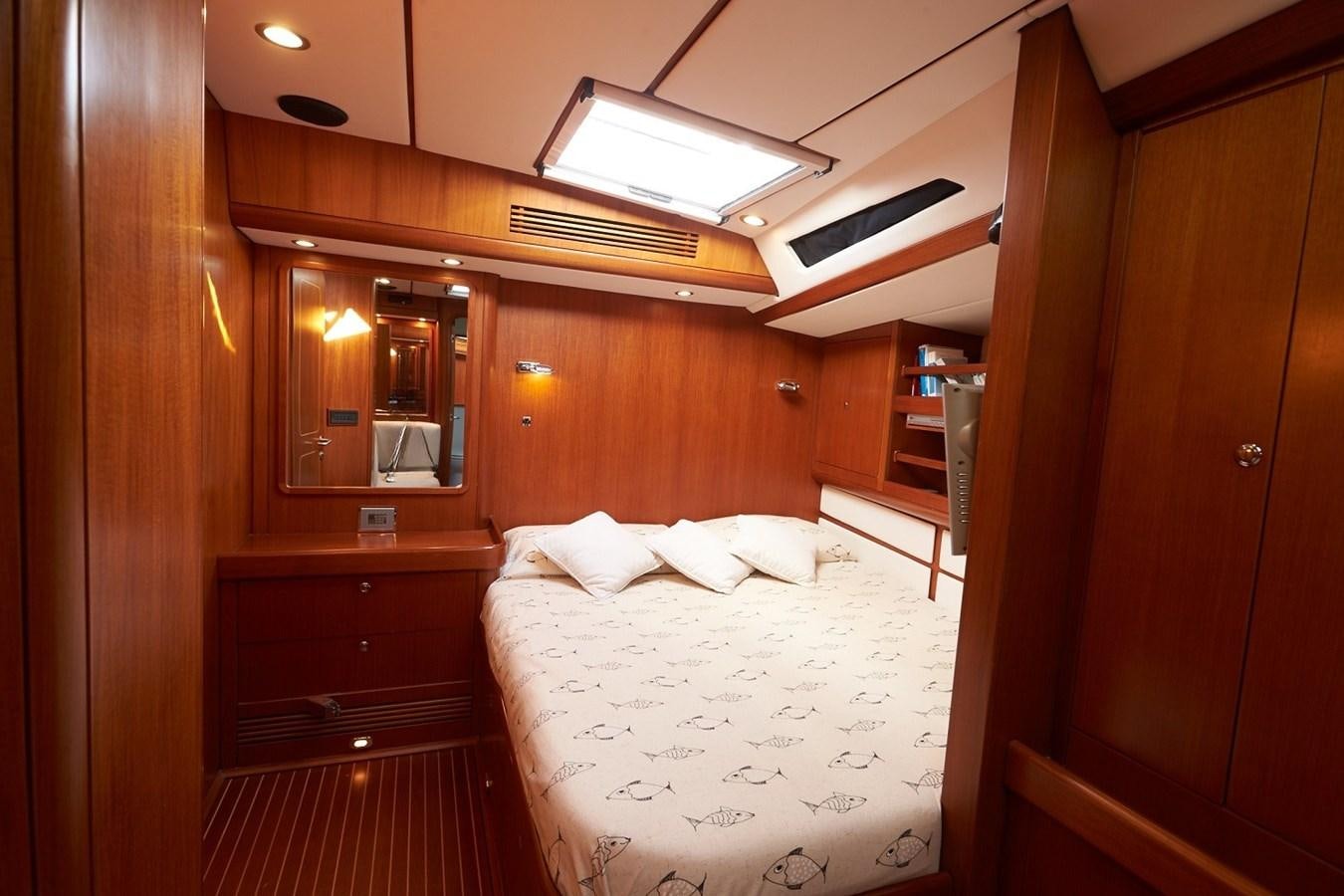 a room with a bed and a mirror aboard FAR OUT Yacht for Sale