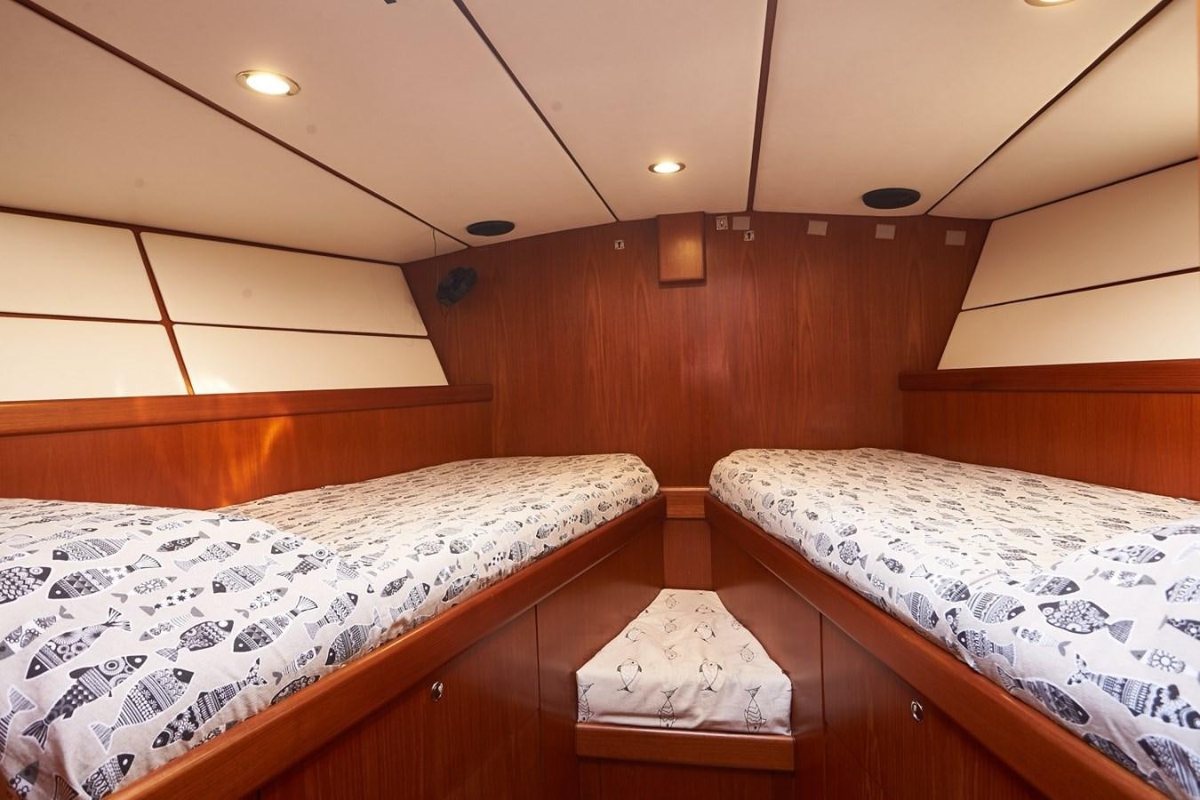 a couple of beds in a room aboard FAR OUT Yacht for Sale