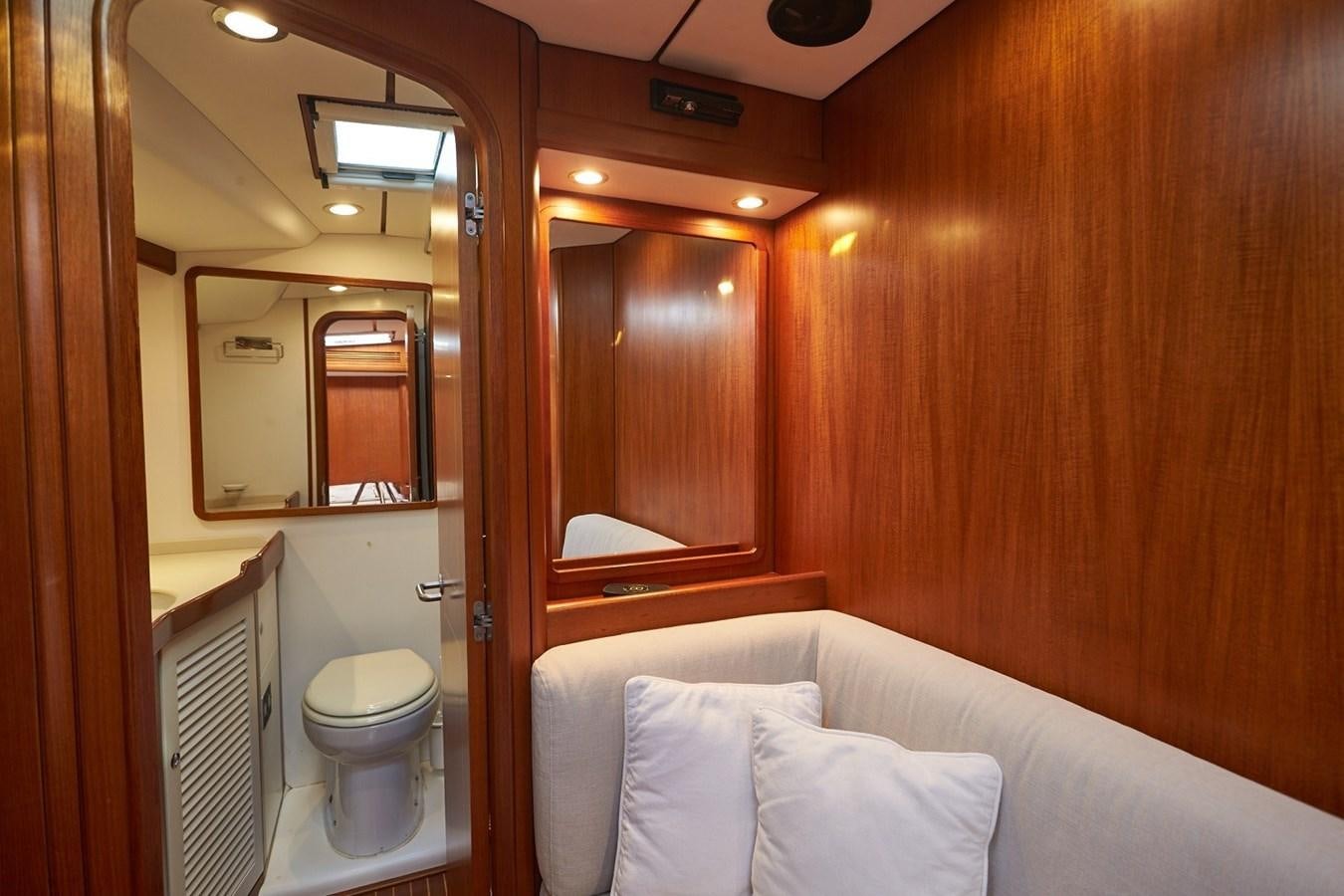 a bathroom with a bed and a mirror aboard FAR OUT Yacht for Sale