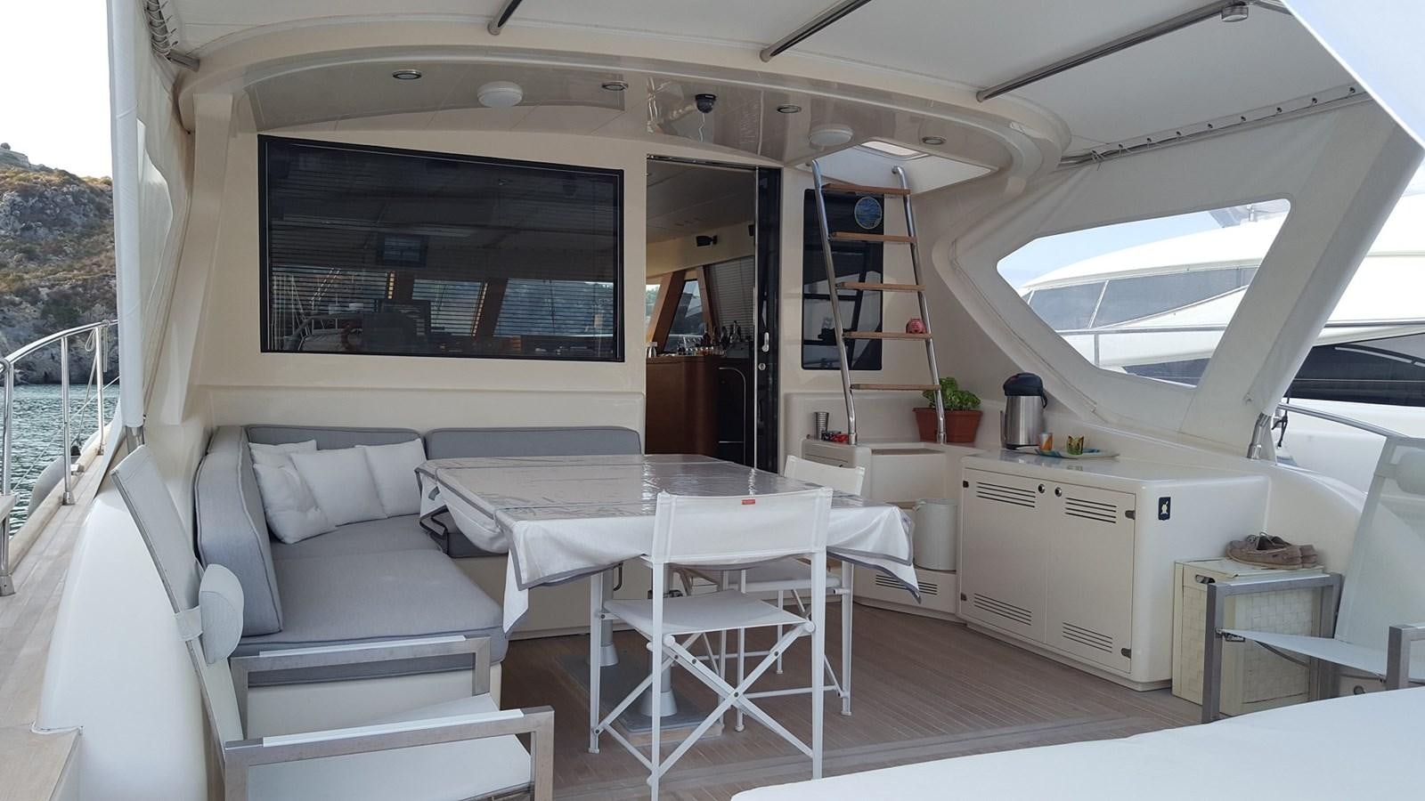 a small living room with a table and chairs aboard NOI TOY Yacht for Sale