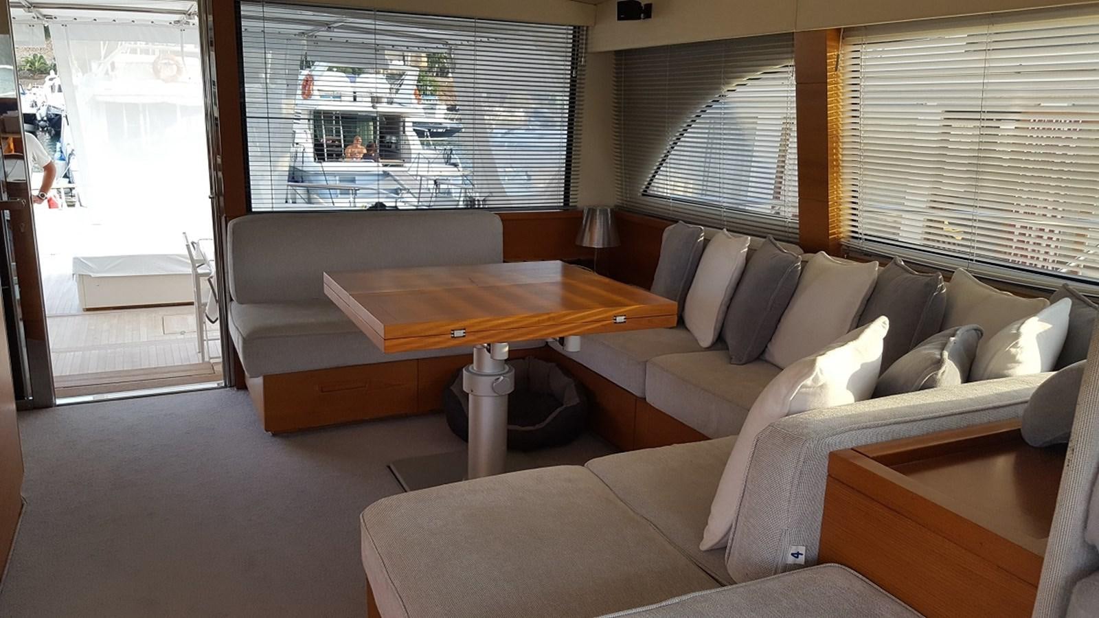 a living room with a couch and a coffee table aboard NOI TOY Yacht for Sale