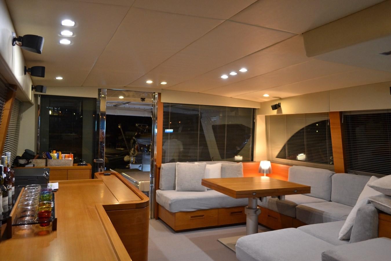a living room with a table and couches aboard NOI TOY Yacht for Sale