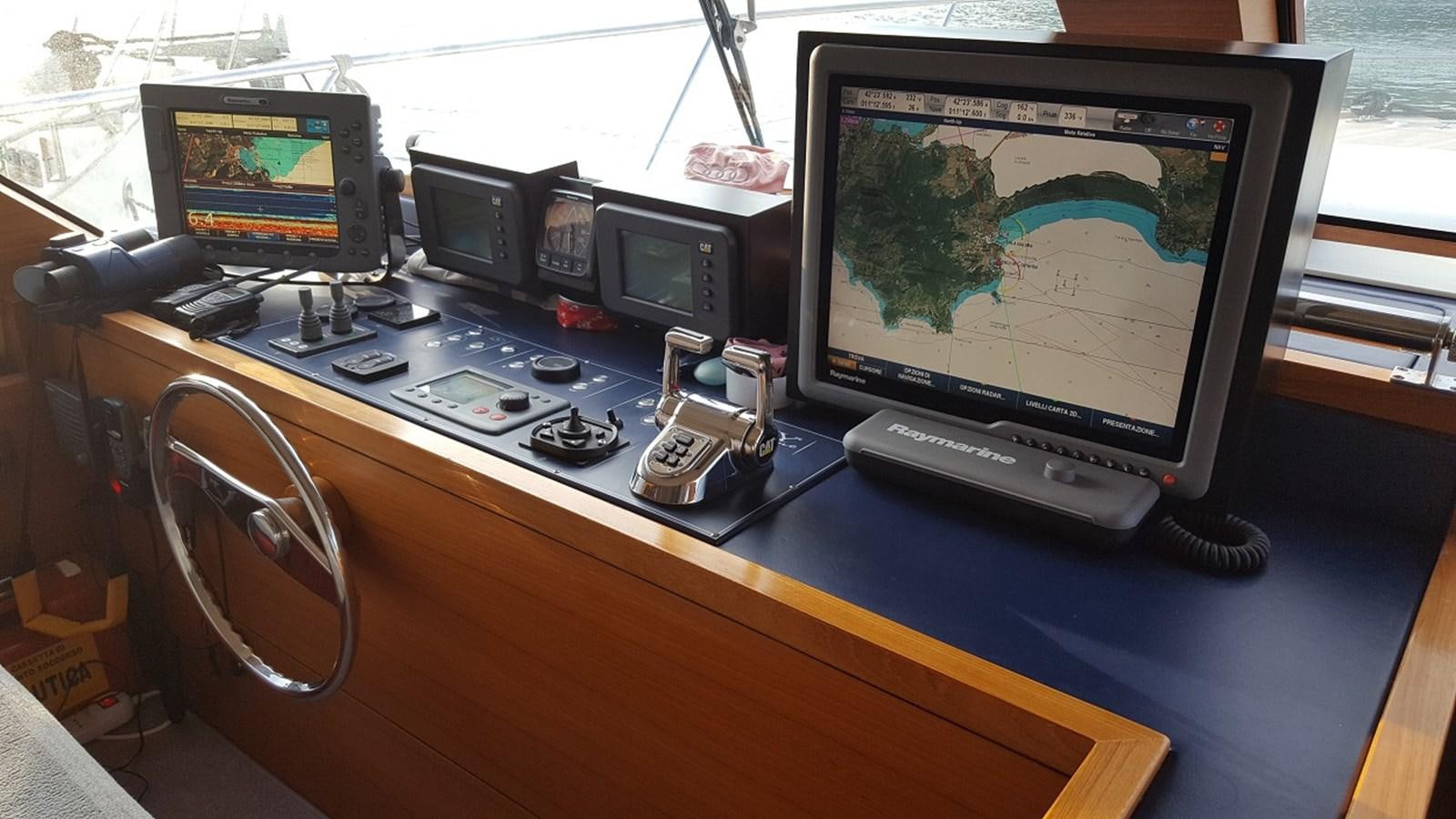 a desk with computers and other electronics aboard NOI TOY Yacht for Sale