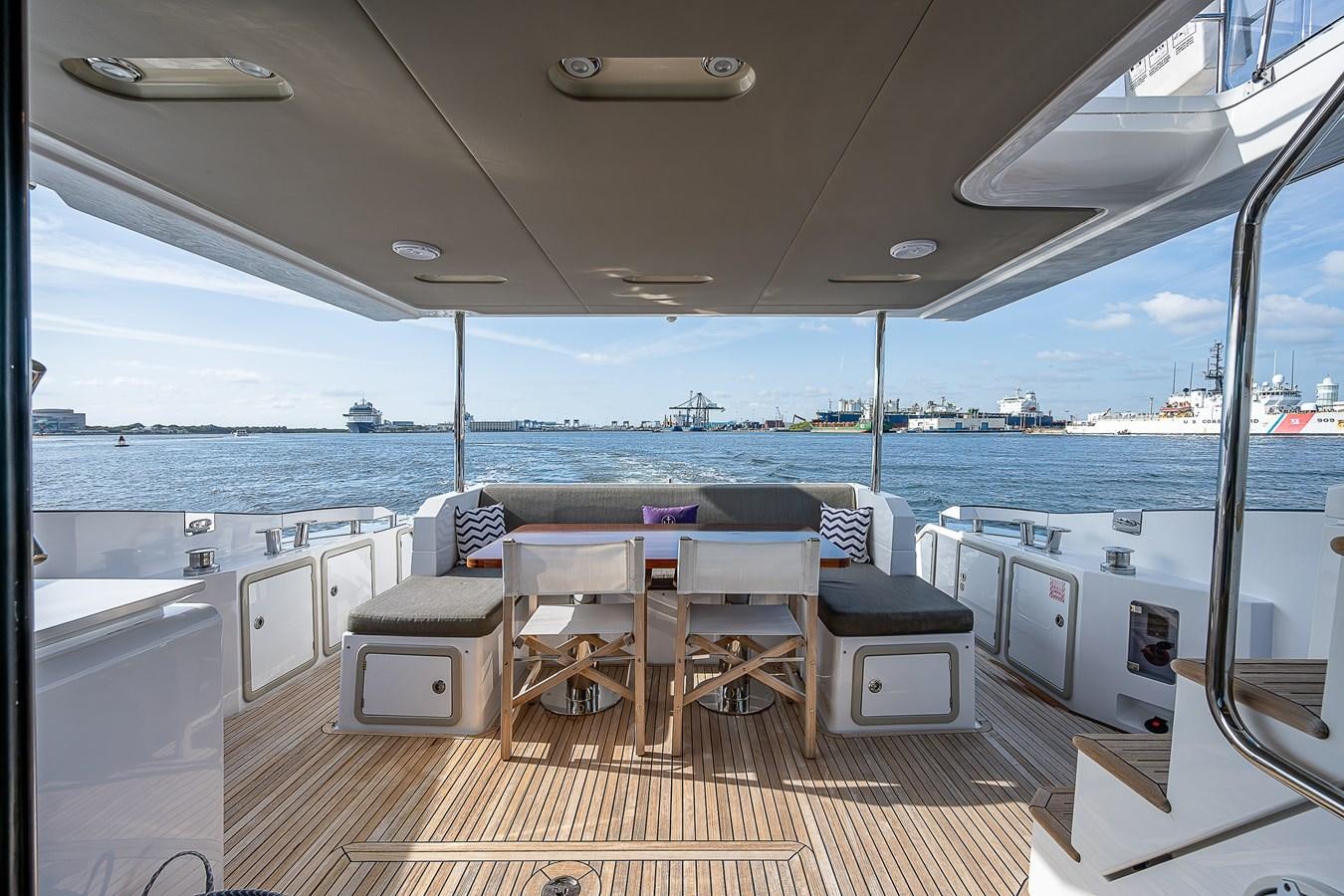 a boat with a table and chairs aboard FITZ SEA Yacht for Sale