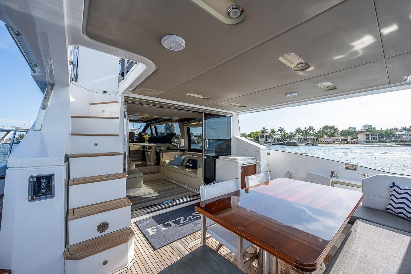 a room with a table and a bed aboard FITZ SEA Yacht for Sale