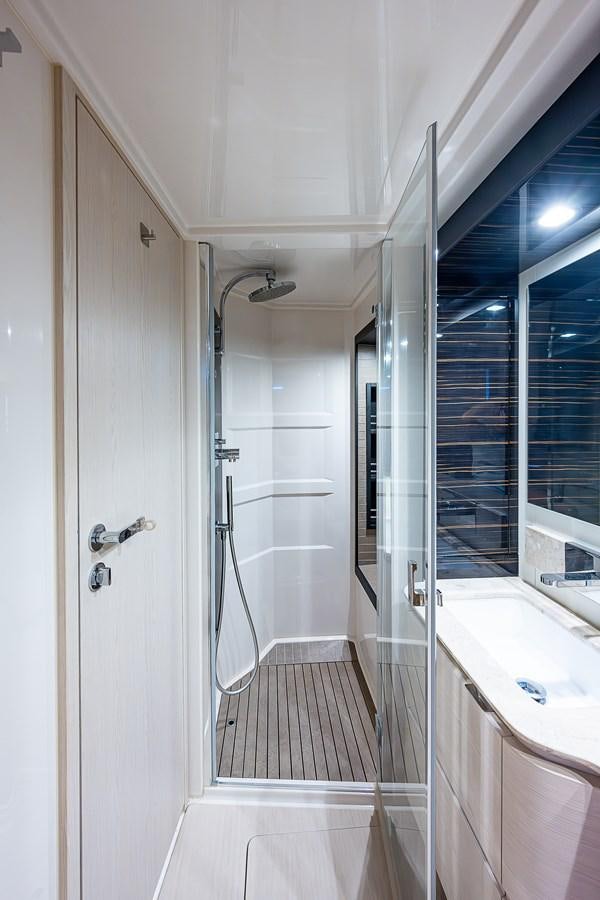 a bathroom with a shower unit and sinks aboard FITZ SEA Yacht for Sale