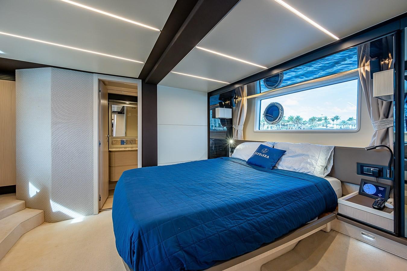 a bedroom with a large blue bed aboard FITZ SEA Yacht for Sale