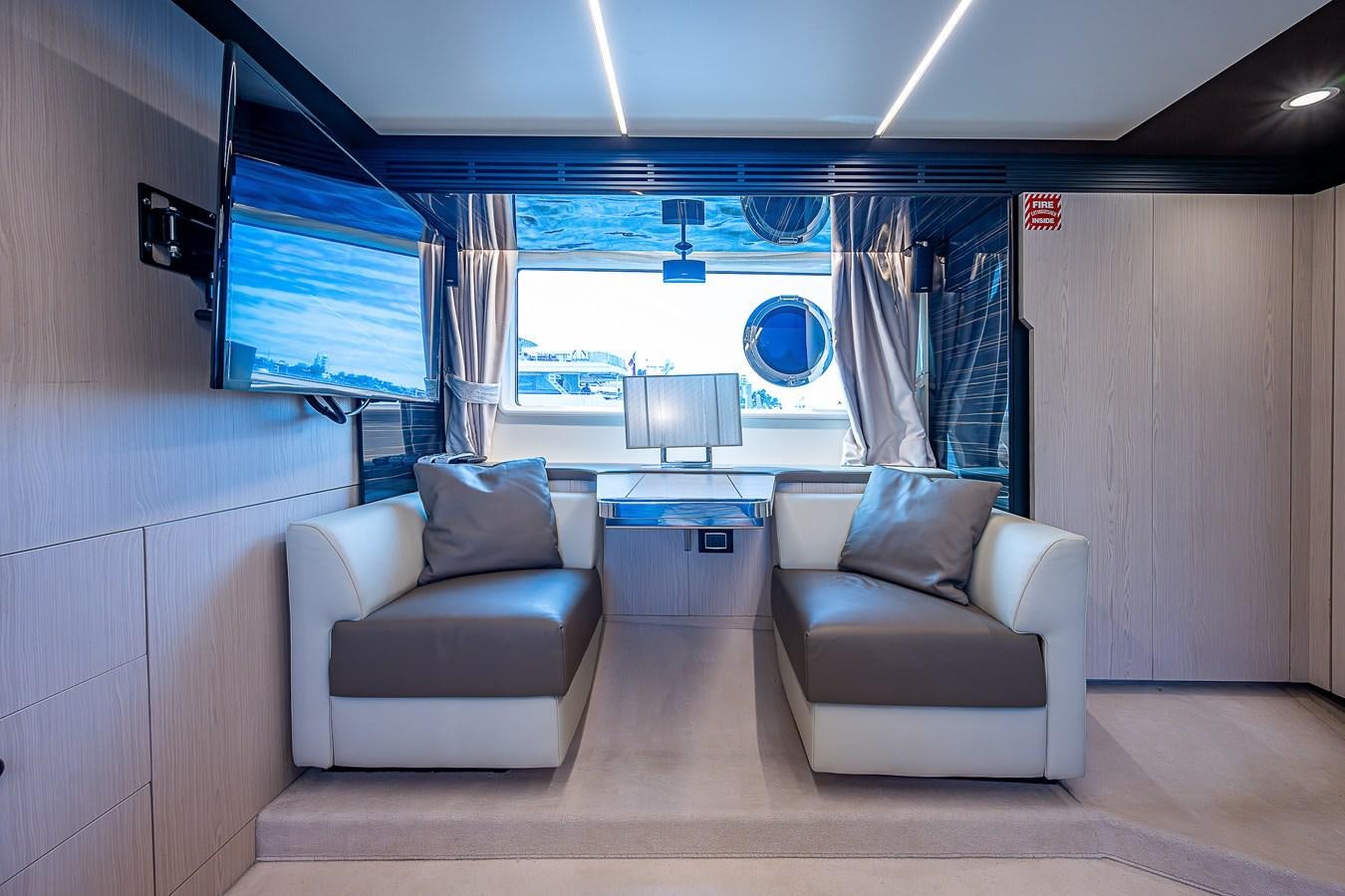 a room with a couch and a window aboard FITZ SEA Yacht for Sale