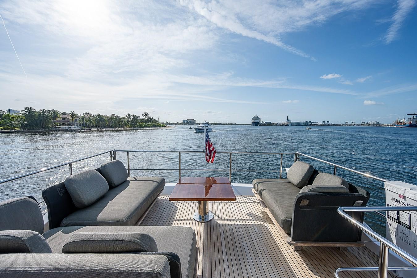 a deck with chairs and a body of water in the background aboard FITZ SEA Yacht for Sale