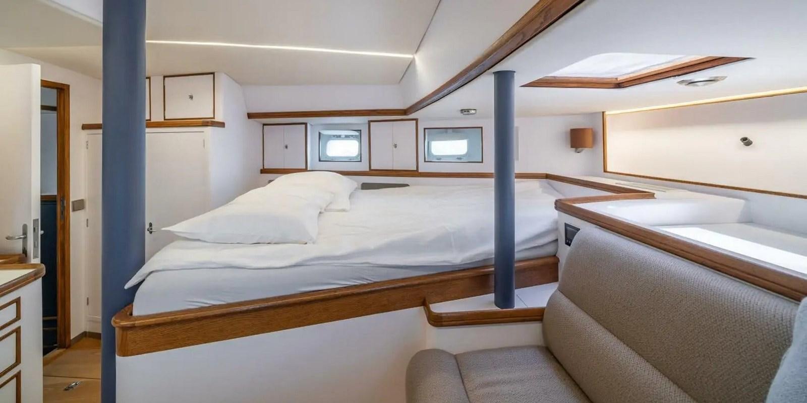 a room with a bed and a couch aboard ALTAIR Yacht for Sale