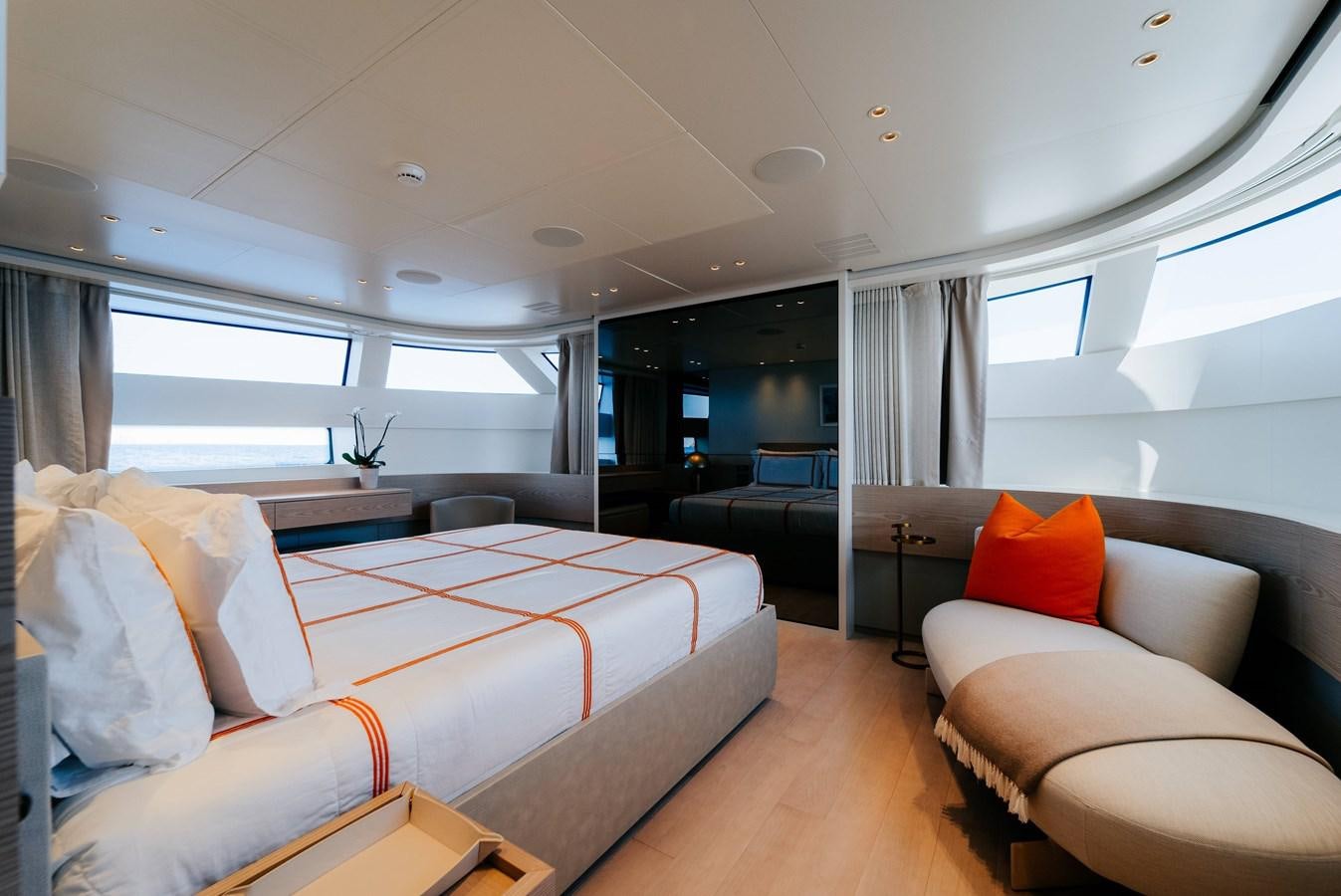 a room with a couch and a table and a window aboard PEARL Yacht for Sale