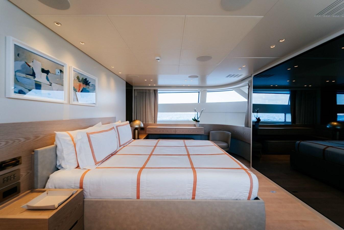 a bedroom with a bed and a desk aboard PEARL Yacht for Sale