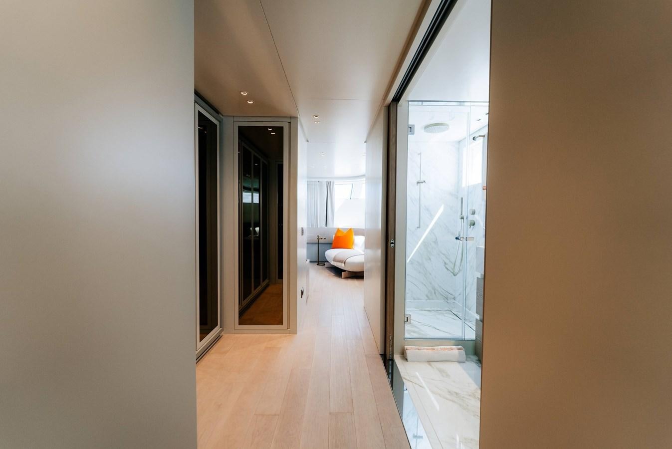 a hallway with a door and a couch aboard PEARL Yacht for Sale