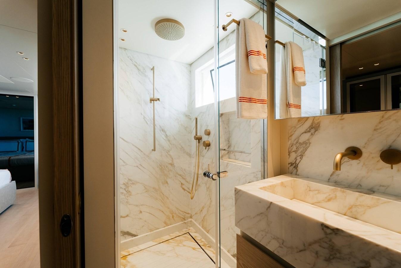 a bathroom with a bathtub and shower aboard PEARL Yacht for Sale