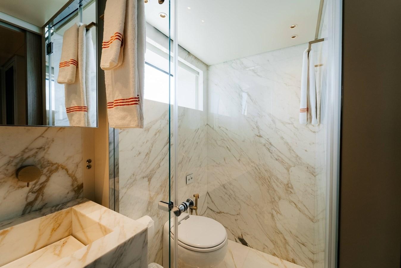 a bathroom with a glass shower aboard PEARL Yacht for Sale