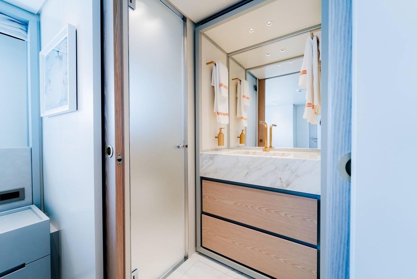 a bathroom with a large mirror aboard PEARL Yacht for Sale