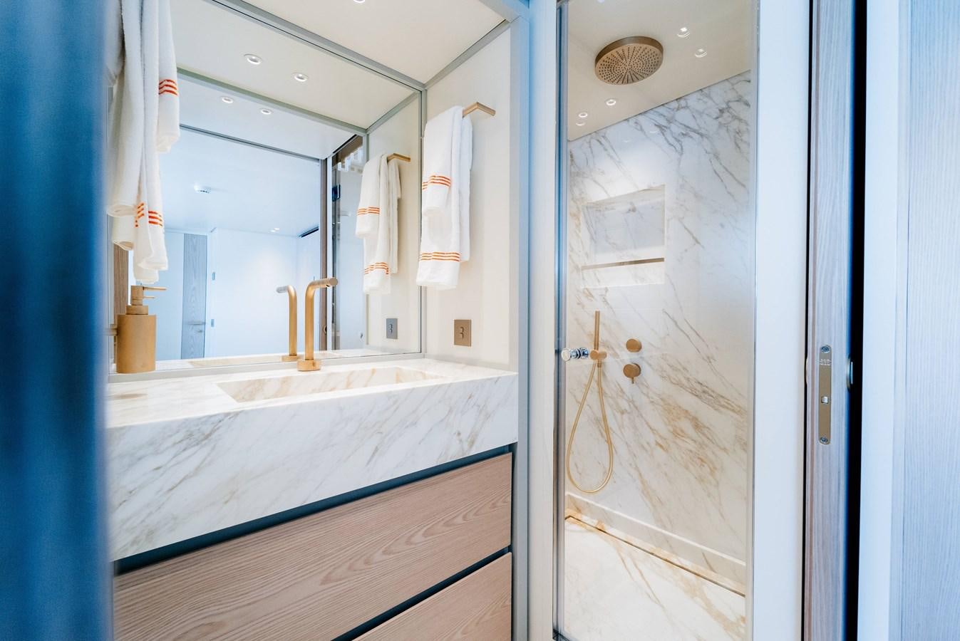 a bathroom with a large mirror aboard PEARL Yacht for Sale